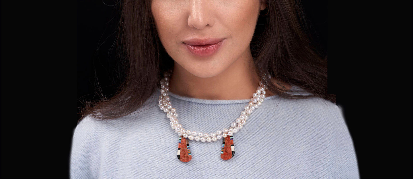 white pearl necklace with red pendants
